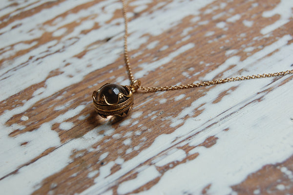 encased glass ball pendant | bronze